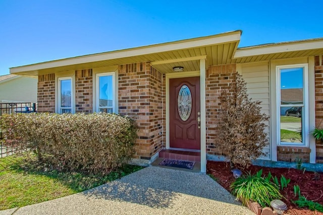 doorway to property with brick siding