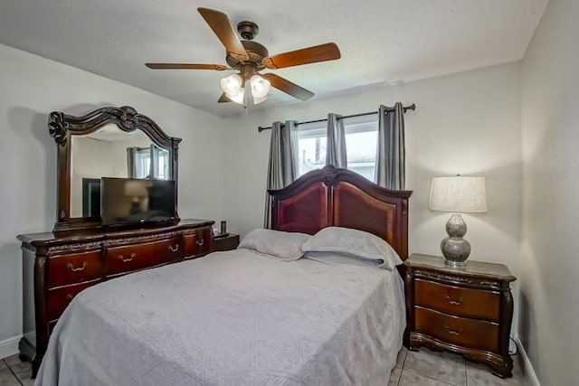 bedroom with light tile patterned floors, baseboards, and a ceiling fan