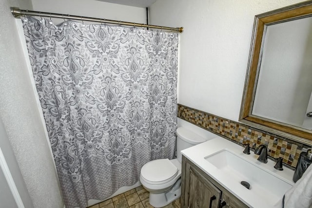 full bath featuring toilet, backsplash, vanity, and shower / bath combo with shower curtain