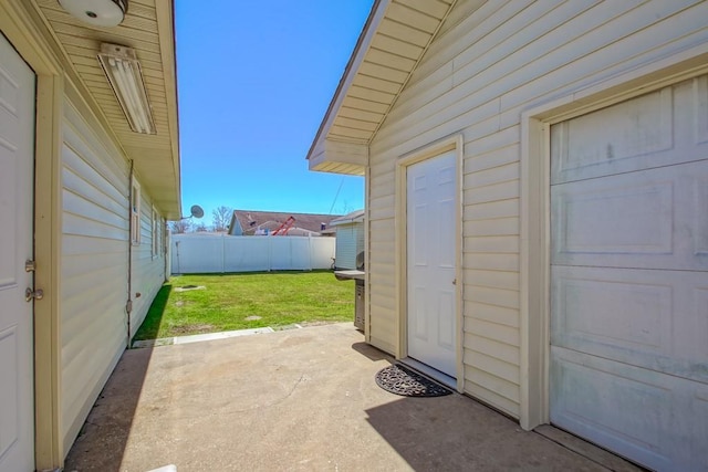 exterior space with a garage, a patio area, and fence