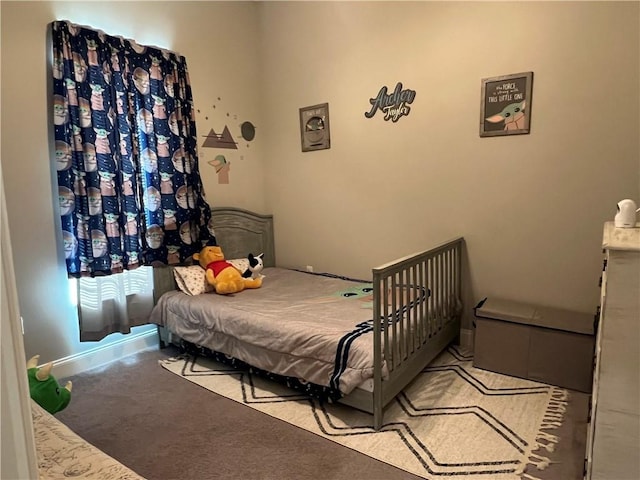 bedroom with light carpet and baseboards