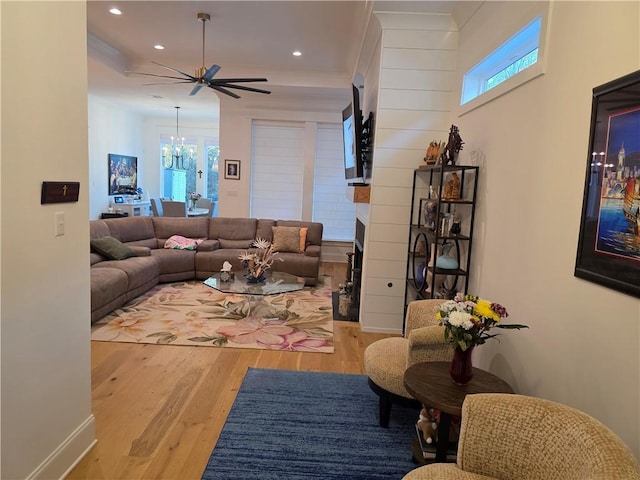 living area featuring a wealth of natural light, wood finished floors, recessed lighting, and ceiling fan with notable chandelier
