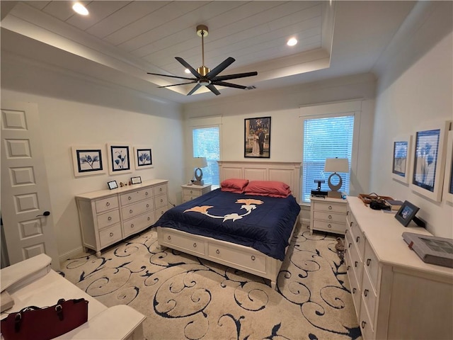 bedroom featuring baseboards, a tray ceiling, ornamental molding, recessed lighting, and a ceiling fan
