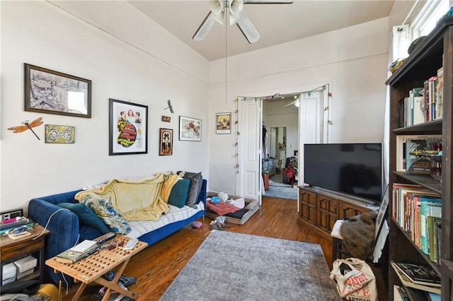 living area featuring a ceiling fan and wood finished floors