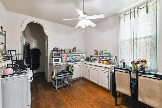 kitchen featuring white appliances, white cabinets, dark wood-style floors, ceiling fan, and light countertops