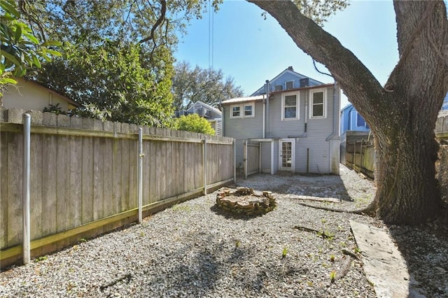 rear view of house with a fenced backyard