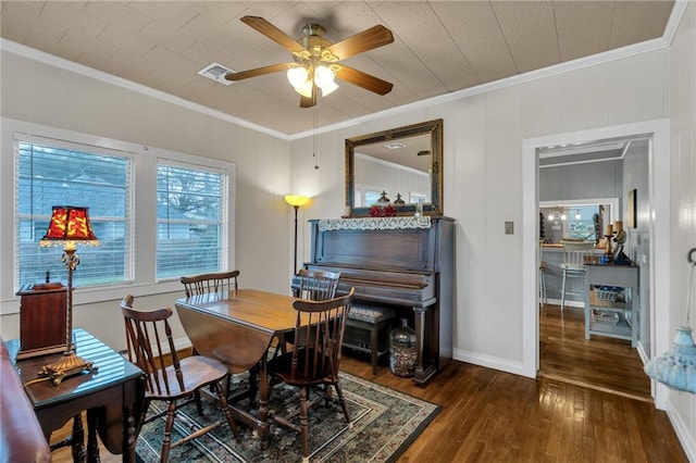 dining area featuring ceiling fan, ornamental molding, hardwood / wood-style flooring, and baseboards