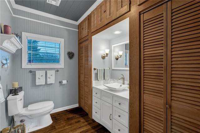 bathroom with toilet, crown molding, a closet, and wood finished floors