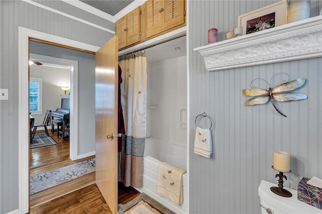 bathroom with curtained shower and wood finished floors