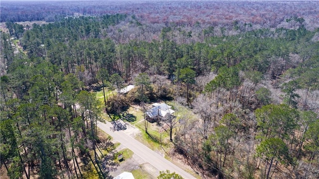 drone / aerial view featuring a wooded view