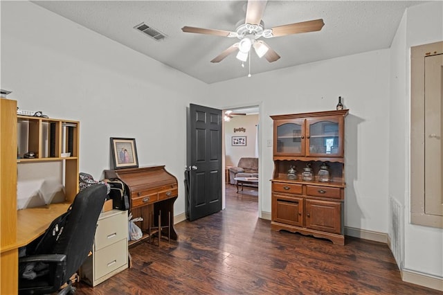 office area featuring visible vents, dark wood-type flooring, a ceiling fan, a textured ceiling, and baseboards