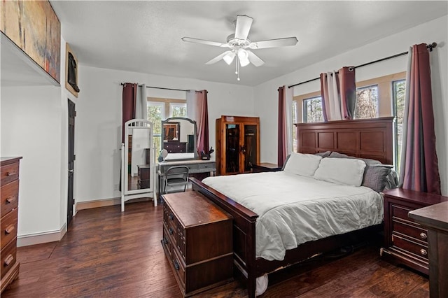 bedroom featuring ceiling fan, dark wood finished floors, and baseboards