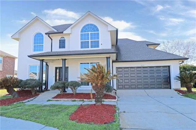 view of front of property featuring concrete driveway, roof with shingles, an attached garage, and stucco siding