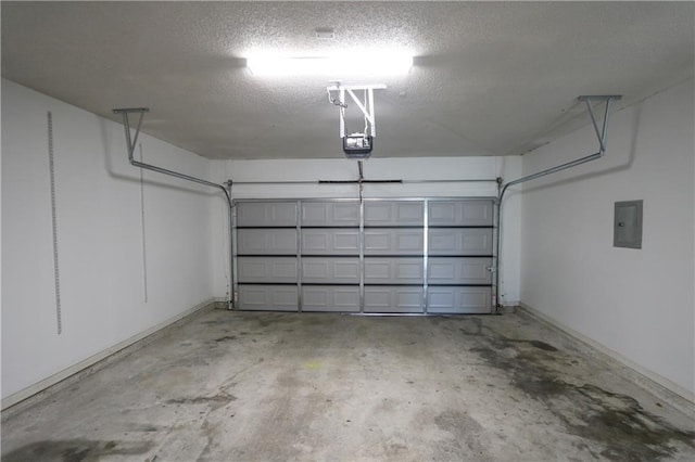 garage featuring electric panel and a garage door opener