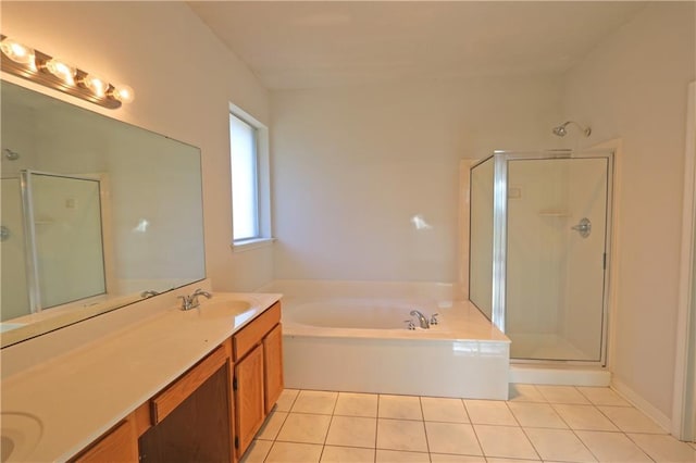 bathroom with a bath, a stall shower, tile patterned flooring, and a sink