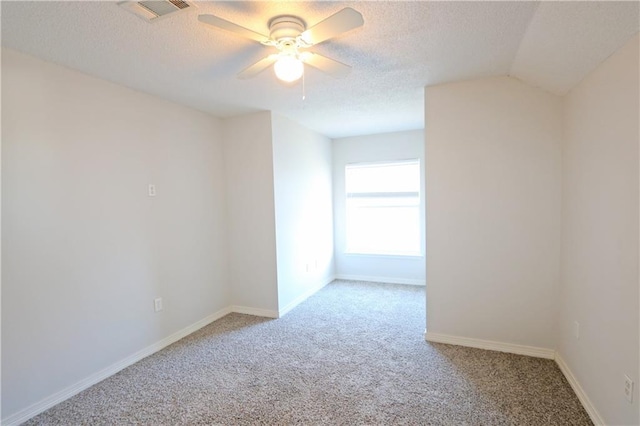 carpeted empty room featuring visible vents, ceiling fan, a textured ceiling, and baseboards