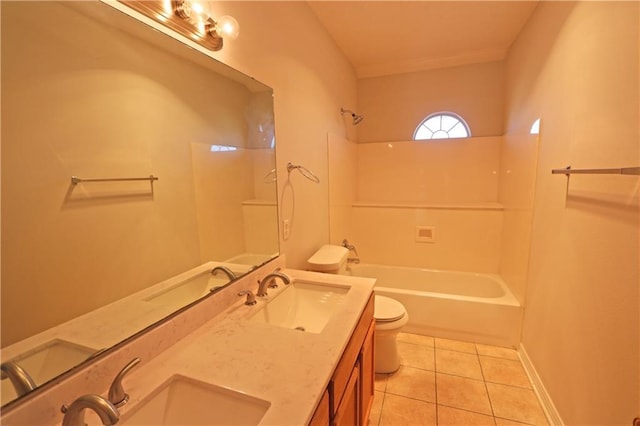 bathroom with toilet, tile patterned flooring, and a sink