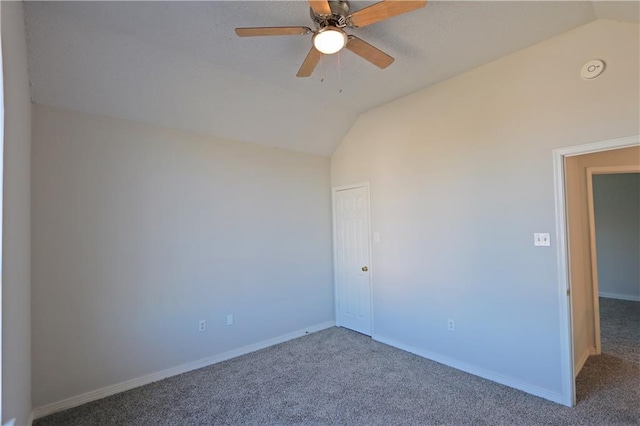 empty room with lofted ceiling, carpet, baseboards, and ceiling fan