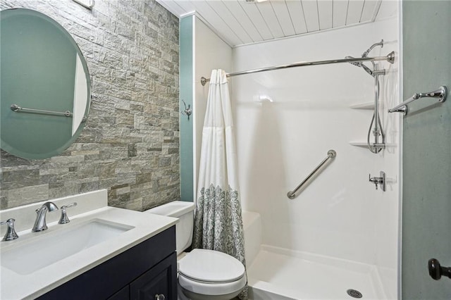 bathroom featuring toilet, curtained shower, wooden ceiling, and vanity