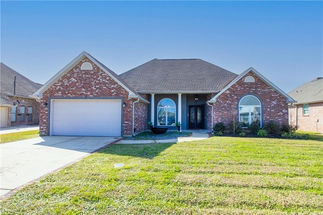 view of front of home featuring an attached garage, brick siding, concrete driveway, roof with shingles, and a front yard