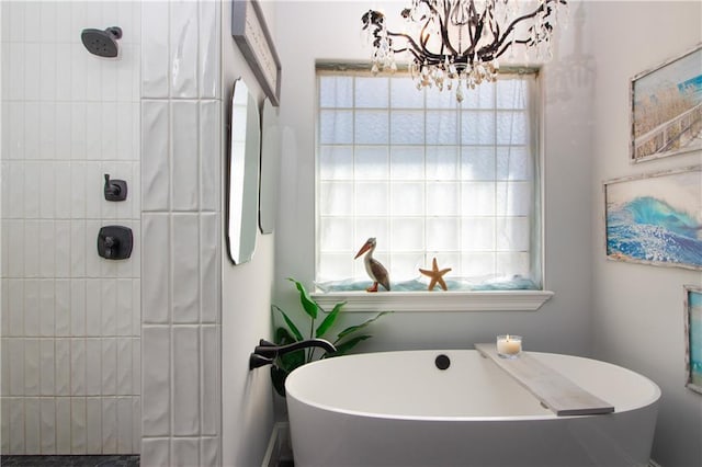 bathroom with a soaking tub and a tile shower