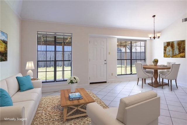 living area featuring a wealth of natural light, visible vents, an inviting chandelier, and light tile patterned floors