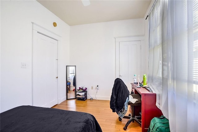 bedroom featuring wood finished floors and baseboards