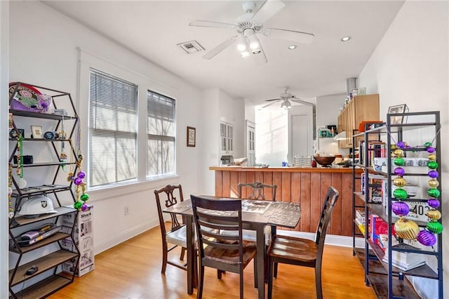 dining room with light wood finished floors, recessed lighting, visible vents, a ceiling fan, and baseboards