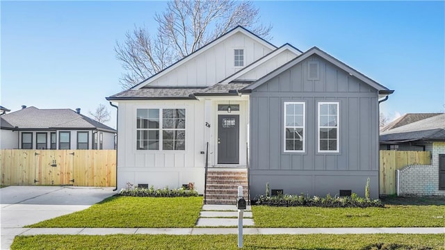 view of front of home featuring roof with shingles, crawl space, board and batten siding, and fence