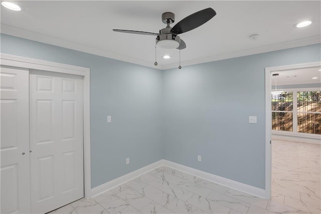 spare room featuring marble finish floor and baseboards