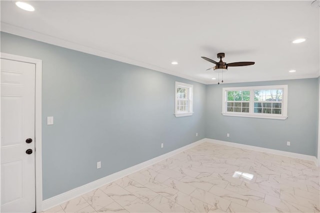 empty room featuring baseboards, ornamental molding, recessed lighting, a ceiling fan, and marble finish floor