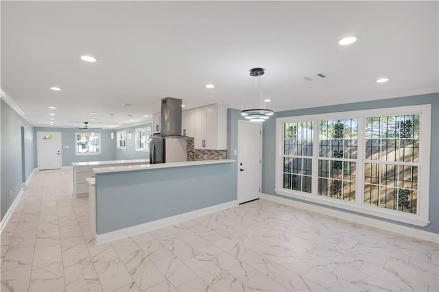 kitchen with baseboards, recessed lighting, marble finish floor, and island exhaust hood