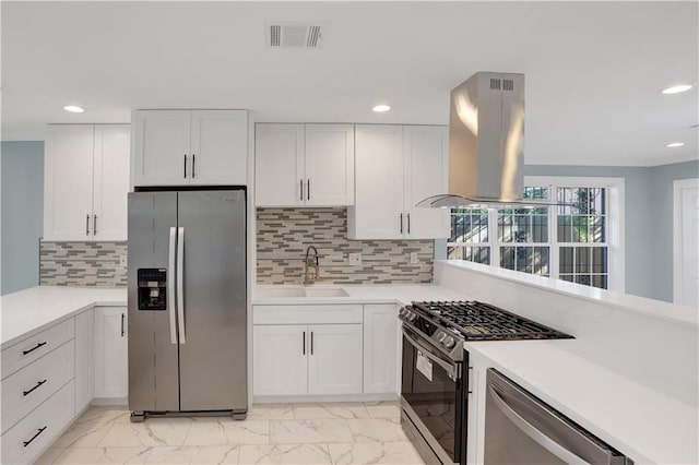 kitchen with white cabinets, light countertops, a sink, stainless steel appliances, and island range hood