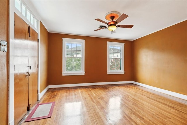 4500 S Rocheblave St, New Orleans, LA 70125 - empty room with light wood-type flooring, baseboards, ornamental molding, and a ceiling fan