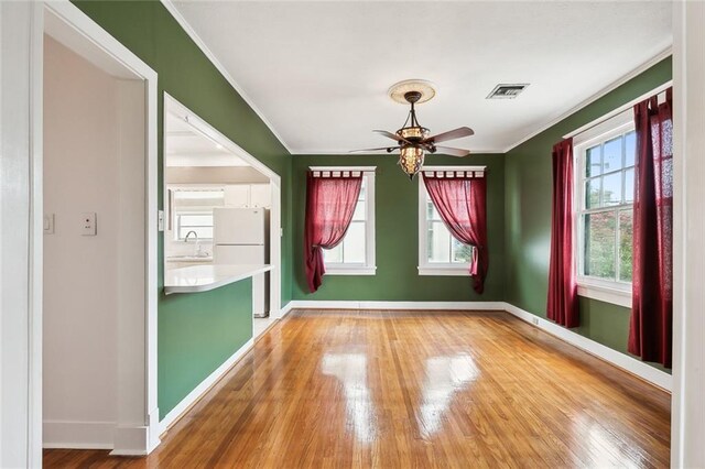 4500 S Rocheblave St, New Orleans, LA 70125 - unfurnished room featuring a sink, ornamental molding, ceiling fan, and hardwood / wood-style floors