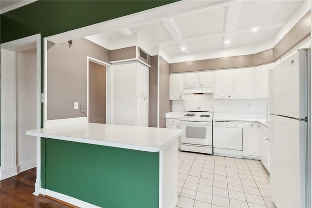 4500 S Rocheblave St, New Orleans, LA 70125 - kitchen featuring white appliances, under cabinet range hood, light countertops, white cabinets, and recessed lighting