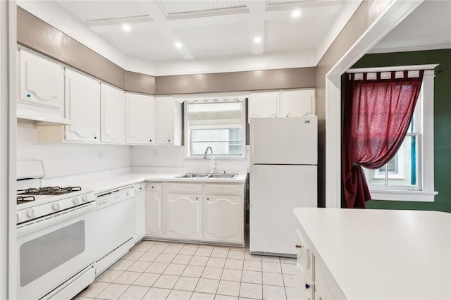 4500 S Rocheblave St, New Orleans, LA 70125 - kitchen with white appliances, a sink, light tile patterned floors, white cabinets, and healthy amount of natural light
