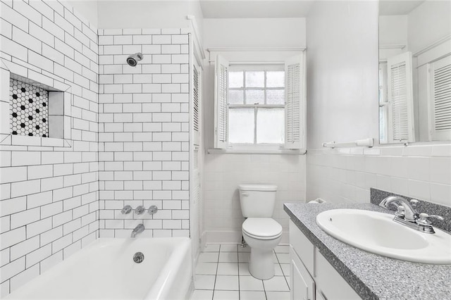 4500 S Rocheblave St, New Orleans, LA 70125 - bathroom featuring tile patterned floors, vanity, toilet, bathtub / shower combination, and tile walls