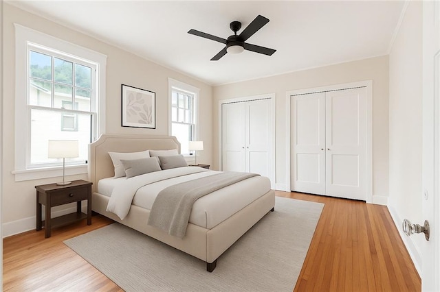 4500 S Rocheblave St, New Orleans, LA 70125 - bedroom with multiple closets, multiple windows, and light wood-type flooring
