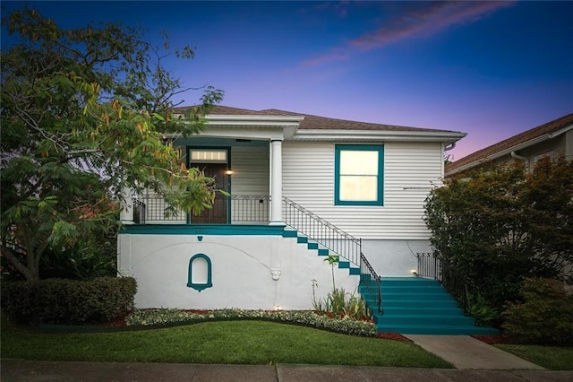 4500 S Rocheblave St, New Orleans, LA 70125 - view of front of home with stairway, a porch, and a yard