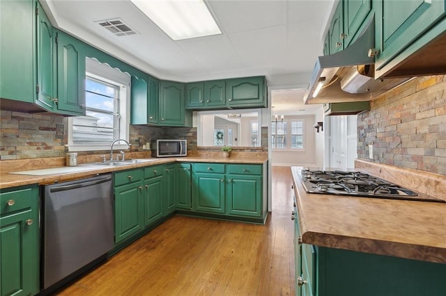 kitchen featuring appliances with stainless steel finishes, a healthy amount of sunlight, visible vents, and a sink