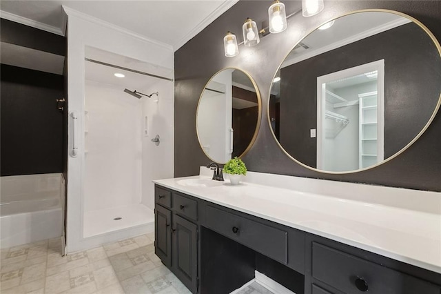 bathroom with a stall shower, vanity, and crown molding