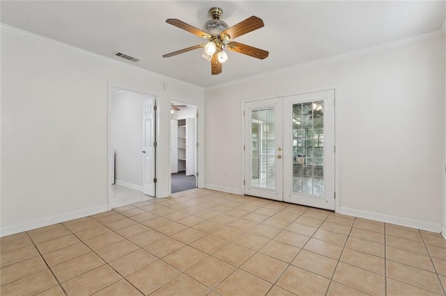 unfurnished room featuring ceiling fan, visible vents, baseboards, ornamental molding, and french doors