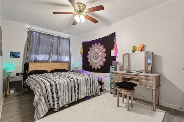 bedroom with baseboards, ceiling fan, light wood-style floors, and crown molding