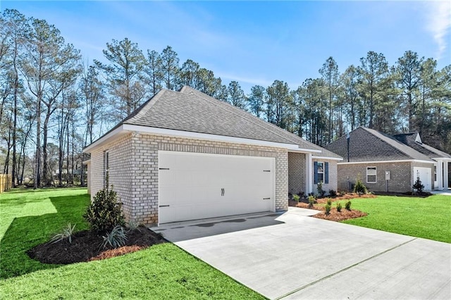 view of front of house featuring a garage, a front yard, concrete driveway, and brick siding