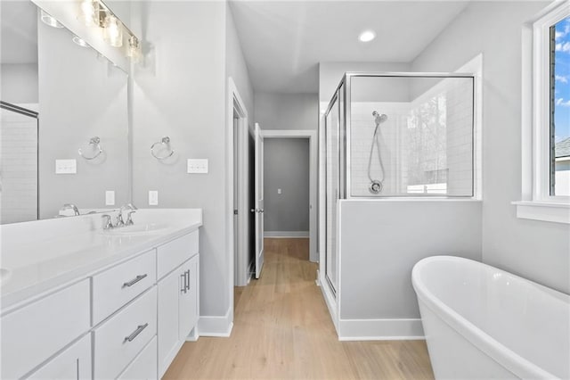 bathroom featuring a healthy amount of sunlight, a shower stall, and vanity