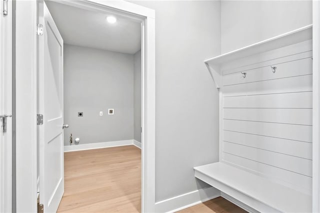 mudroom featuring light wood-style flooring and baseboards