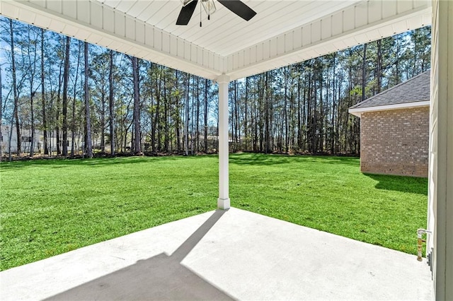 view of yard featuring ceiling fan and a patio