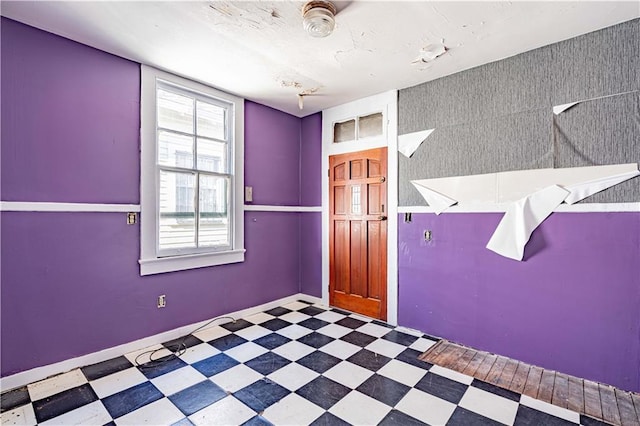 empty room featuring baseboards and tile patterned floors