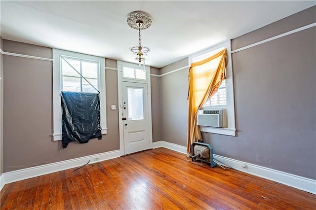 entrance foyer featuring hardwood / wood-style floors, baseboards, and cooling unit